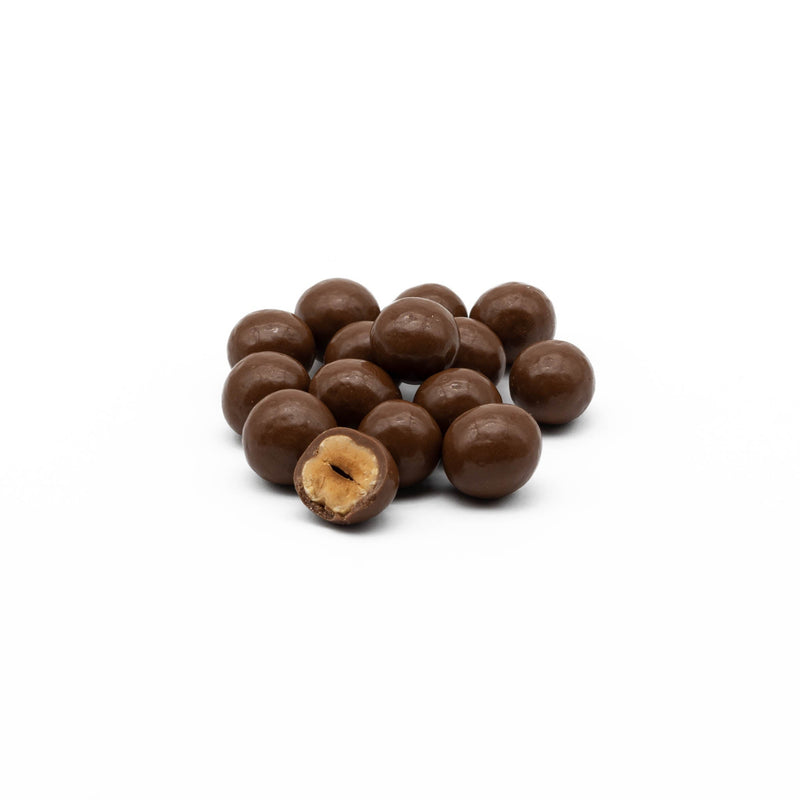 Blanched hazels, coated in layers of milk chocolate